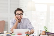 CEO smiling at his desk