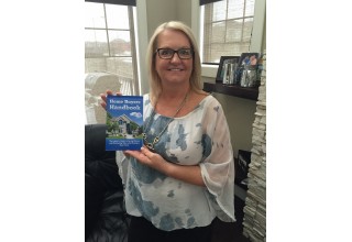 Eva Neufeld with her book