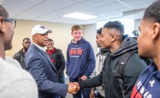 Coach meeting football players