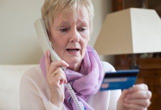 Woman Making a Payment Over the Phone