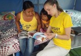 A Scientology Volunteer Minister shows a mother how to perform a Scientology assist for her daughter.