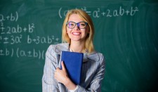 Happy Student in Front of Blackboard