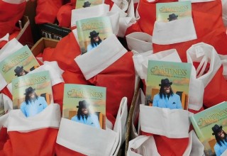 Christmas stockings with a copy of The Way to Happiness