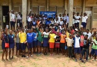 Children hold up their Youth for Human Rights booklets 