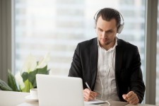 CEO of Small Business Taking Notes from Computer