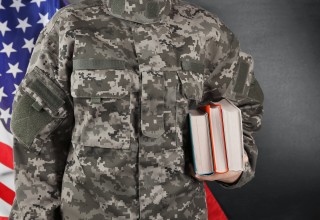 Veteran Holding Books for College