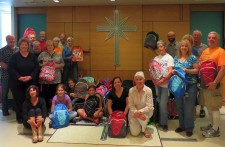 Volunteers from Interfaith Ministries of Greater Queen Anne at a luncheon at the Church of Scientology Seattle, where they prepared backpacks and school supplies for local underserved children in the new school year.