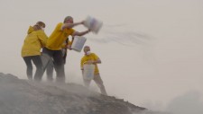 Scientology Volunteer Ministers preventing blowing embers from spreading the fire to undamaged buildings.