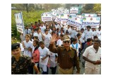 Participants in The Way to Happiness march on International Day of Happiness carry signs bearing the precepts of the moral code.