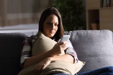 Woman concentrating while looking at her phone