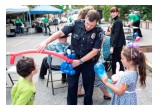 A policeman entertained two children with balloon art at the National Night Out block party at the Church of Scientology Seattle.