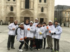 Volunteers from The Way to Happiness Foundation of France gather to launch a neighborhood cleanup.