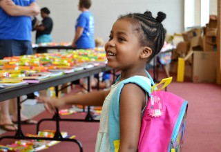 Child Receiving School Supplies