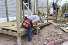 Volunteer building a ramp for manufactured home