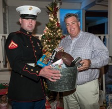 Joe Fijol, Managing Partner at 360 Destination Group presents toys to Toys for Tots