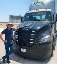 Sam Johal poses with Freightliner eCascadia