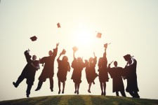 Graduating College Students Throwing Caps