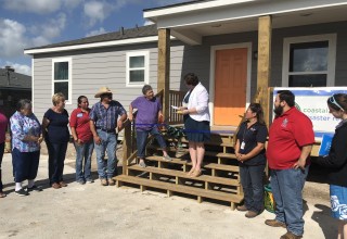 CBDRG Board President, Beth Tatum, hands over keys to completed rebuilt home in Refugio resident