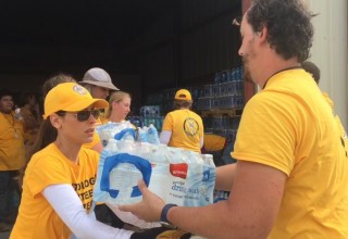 As part of the Scientology Volunteer Ministers team in Rockport, Texas, Kerri Kasim helps organize donated water to distribute to the community.