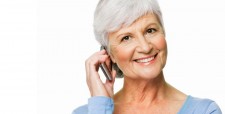 Smiling patient paying her bill over the phone