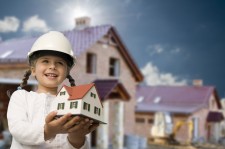 Girl Holding Model House Signifying Family Life