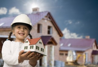 Girl Holding Model House Signifying Family Life