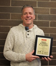 Bob Thomas Displaying the Portland Business Journal Most Admired Company Award