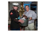 Joe Fijol, Managing Partner at 360 Destination Group presents toys to Toys for Tots