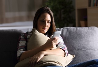 Woman concentrating while looking at her phone