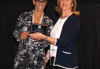 Dr. Bello gives Diana Rowan Rockefeller the Woman of the Year Award January 2019