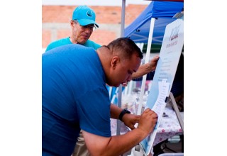 Another official signs the pledge.