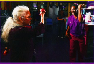 Exercise Physiologist Akua Adu-Labi leads pulmonary patient through arm exercises.