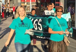 Volunteers march to Parliament to raise awareness on drug education.