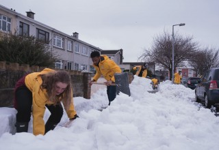 Volunteers from the Scientology Community Centre help the community dig out from the snowstorm