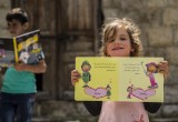 Refugee girl receives a book from Bookwitty