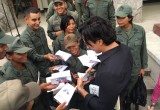 Eduardo Galán autographs copies of The Way to Happiness at National Guard workshop