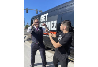 Attorney John Gomez and UFC Champion Brandon Moreno pose in their fight stances