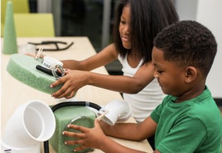 Siblings team up on a rainy afternoon to complete their STEAM projects