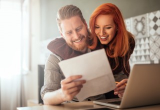 Happy Couple Looking at Finances