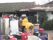 Volunteer Ministers in bright yellow jackets assisting the Stickles family sort through their remaining possessions.