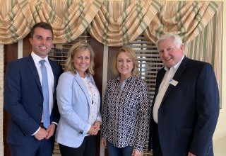 Stutzman smiles with representatives from the IHCA and Short Strategy Group