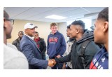 Coach meeting football players