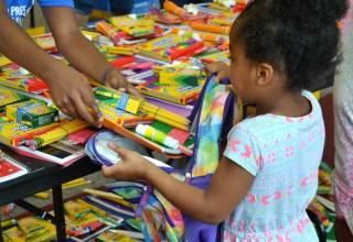 Child Receiving School Supplies