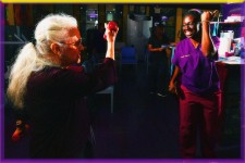 Exercise Physiologist Akua Adu-Labi leads pulmonary patient through arm exercises.