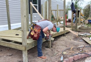 Volunteer building a ramp for manufactured home