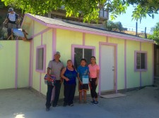 The Real Family standing in front of their new home in Tijuana.